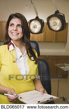 Picture - mixed race doctor 
in doctor’s office. 
fotosearch - search 
stock photos, 
pictures, images, 
and photo clipart