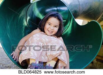 Stock Image - mixed race girl 
sliding in playground. 
fotosearch - search 
stock photos, 
pictures, images, 
and photo clipart