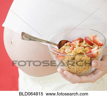 Stock Image - pregnant asian 
woman holding 
healthy cereal. 
fotosearch - search 
stock photos, 
pictures, images, 
and photo clipart