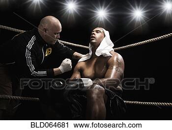 Stock Photography - trainer talking 
to african boxer 
in ring. fotosearch 
- search stock 
photos, pictures, 
images, and photo 
clipart