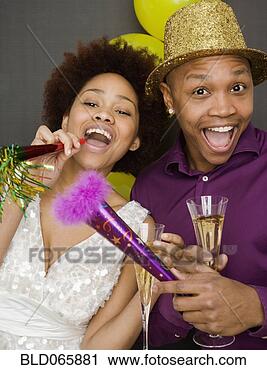 Stock Photography - african couple 
in party hats 
on new year’s 
eve. fotosearch 
- search stock 
photos, pictures, 
images, and photo 
clipart