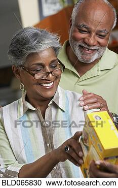 Stock Photography - african couple 
reading food ingredients. 
fotosearch - search 
stock photos, 
pictures, images, 
and photo clipart