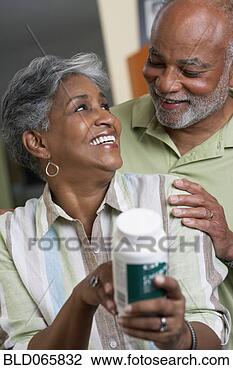 Stock Photo - african couple 
reading vitamin 
ingredients. fotosearch 
- search stock 
photos, pictures, 
images, and photo 
clipart