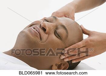 Stock Photography - african man receiving 
massage. fotosearch 
- search stock 
photos, pictures, 
images, and photo 
clipart