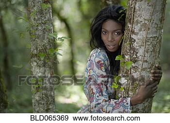 Stock Photograph - african woman 
hugging tree trunk. 
fotosearch - search 
stock photos, 
pictures, images, 
and photo clipart