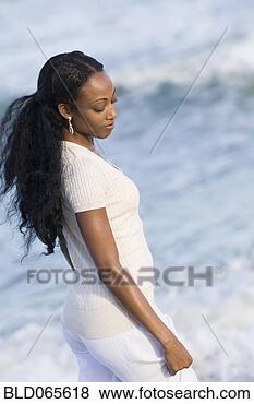 Stock Photo - african woman 
walking near ocean. 
fotosearch - search 
stock photos, 
pictures, images, 
and photo clipart