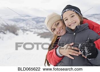 Stock Photo - hispanic mother 
hugging son in 
snow field. fotosearch 
- search stock 
photos, pictures, 
images, and photo 
clipart