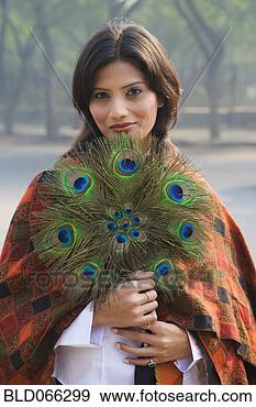 Stock Photograph - indian woman holding 
peacock feather 
fan. fotosearch 
- search stock 
photos, pictures, 
images, and photo 
clipart
