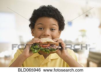 Stock Photo - mixed race boy 
eating healthy 
sandwich. fotosearch 
- search stock 
photos, pictures, 
images, and photo 
clipart