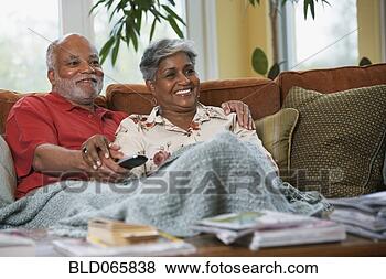 Stock Photo - senior african 
couple watching 
television. fotosearch 
- search stock 
photos, pictures, 
images, and photo 
clipart