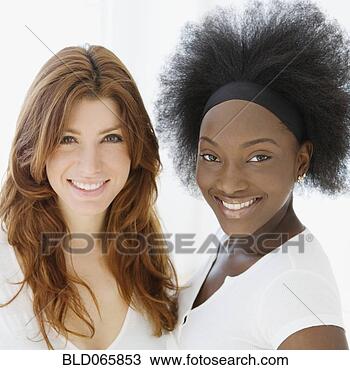 Stock Photo - smiling caucasian 
and african woman. 
fotosearch - search 
stock photos, 
pictures, images, 
and photo clipart