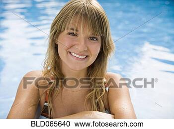 Stock Photography - smiling hispanic 
woman near  swimming 
pool. fotosearch 
- search stock 
photos, pictures, 
images, and photo 
clipart