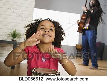 Stock Photo - african father 
and daughter playing 
musical instruments. 
fotosearch - search 
stock photos, 
pictures, images, 
and photo clipart