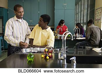 Stock Photo - african teacher 
helping student 
in chemistry lab. 
fotosearch - search 
stock photos, 
pictures, images, 
and photo clipart