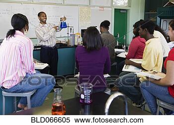 Stock Image - african teacher 
helping students 
in chemistry lab. 
fotosearch - search 
stock photos, 
pictures, images, 
and photo clipart