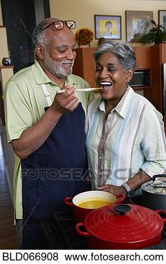 Stock Photo - african woman 
tasting husband’s 
cooking. fotosearch 
- search stock 
photos, pictures, 
images, and photo 
clipart