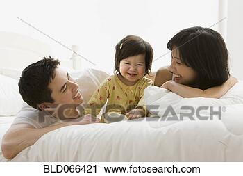 Stock Photography - mixed race girl 
laughing with 
parents. fotosearch 
- search stock 
photos, pictures, 
images, and photo 
clipart