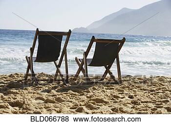 Stock Photo - two empty beach 
chairs on beach. 
fotosearch - search 
stock photos, 
pictures, images, 
and photo clipart