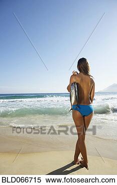 Stock Image - woman at beach 
holding fish. 
fotosearch - search 
stock photos, 
pictures, images, 
and photo clipart