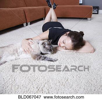 Picture - woman petting 
cat on floor. 
fotosearch - search 
stock photos, 
pictures, images, 
and photo clipart
