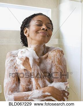 Stock Photograph - senior african 
woman washing 
in shower. fotosearch 
- search stock 
photos, pictures, 
images, and photo 
clipart