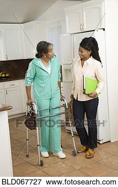 Picture - senior african 
woman with walker 
talking to daughter. 
fotosearch - search 
stock photos, 
pictures, images, 
and photo clipart