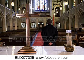 Stock Photo - mixed race pastor 
standing in front 
of church altar. 
fotosearch - search 
stock photos, 
pictures, wall 
murals, images, 
and photo clipart