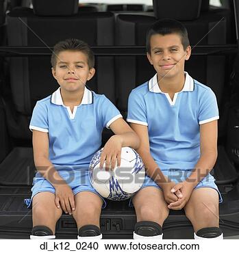 Stock Photography - portrait of two 
boys sitting at 
the back of a 
car wearing soccer. 
fotosearch - search 
stock photos, 
pictures, images, 
and photo clipart
