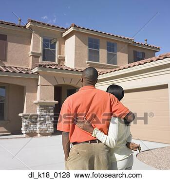 Stock Photo - rear view of a 
mid adult couple 
looking at a house. 
fotosearch - search 
stock photos, 
pictures, images, 
and photo clipart