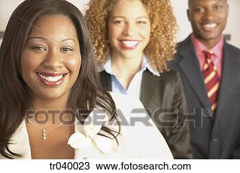 Stock Photo - two young businesswomen 
and a young businessman 
standing one behind. 
fotosearch - search 
stock photos, 
pictures, images, 
and photo clipart