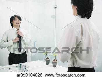 Stock Photo - businessman adjusting 
his tie in a mirror, 
beijing, china. 
fotosearch - search 
stock photos, 
pictures, images, 
and photo clipart