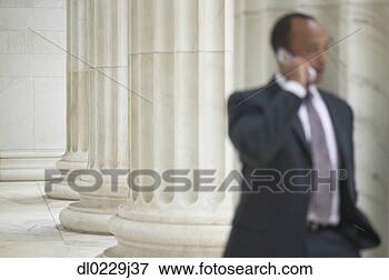 Picture - mid adult businessman 
talking on a mobile 
phone. fotosearch 
- search stock 
photos, pictures, 
images, and photo 
clipart