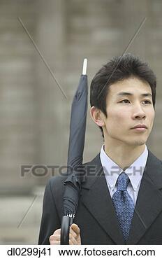 Stock Photography - mid adult businessman 
holding an umbrella. 
fotosearch - search 
stock photos, 
pictures, images, 
and photo clipart