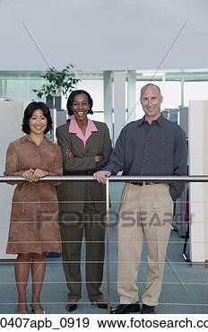 Stock Photograph - two businesswomen 
and a businessman 
standing at a 
railing looking 
at. fotosearch 
- search stock 
photos, pictures, 
images, and photo 
clipart