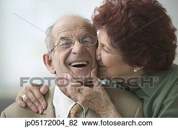 Stock Photo - portrait of a 
senior woman kissing 
a senior man on 
the cheek. fotosearch 
- search stock 
photos, pictures, 
images, and photo 
clipart