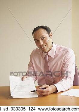 Stock Photo - portrait of a 
businessman pointing 
at a document 
with a pen. fotosearch 
- search stock 
photos, pictures, 
images, and photo 
clipart