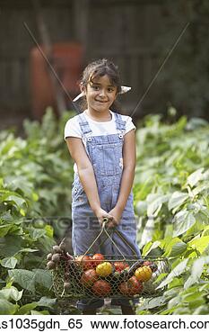 Stock Image - girl holding basket 
of vegetables. 
fotosearch - search 
stock photos, 
pictures, images, 
and photo clipart