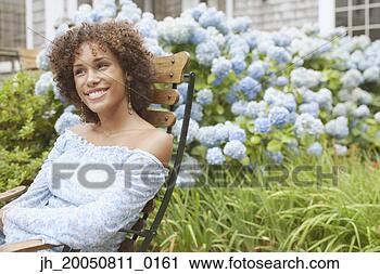 Stock Photography - young woman relaxing 
in a lawn chair. 
fotosearch - search 
stock photos, 
pictures, images, 
and photo clipart