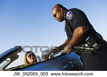 Stock Photo - police officer 
examining driver's 
license of a mid 
adult woman. fotosearch 
- search stock 
photos, pictures, 
images, and photo 
clipart