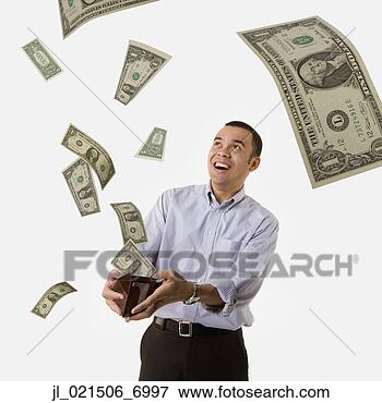 Picture - studio shot of 
man with money 
flying out of 
his wallet. fotosearch 
- search stock 
photos, pictures, 
images, and photo 
clipart