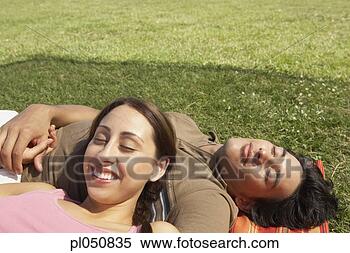 Stock Image - couple sleeping 
on a blanket outdoors. 
fotosearch - search 
stock photos, 
pictures, images, 
and photo clipart