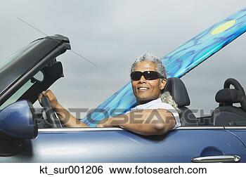 Stock Photo - senior man driving 
a convertible 
with a surfboard 
in it,  oakland. 
fotosearch - search 
stock photos, 
pictures, images, 
and photo clipart
