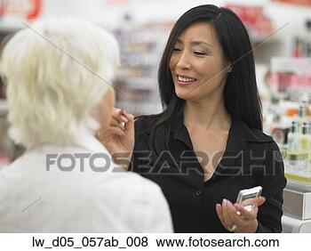Stock Photo - female employee 
applying makeup 
to senior woman's 
face. fotosearch 
- search stock 
photos, pictures, 
images, and photo 
clipart