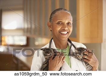 Stock Photography - female veterinarian 
holding kittens. 
fotosearch - search 
stock photos, 
pictures, images, 
and photo clipart