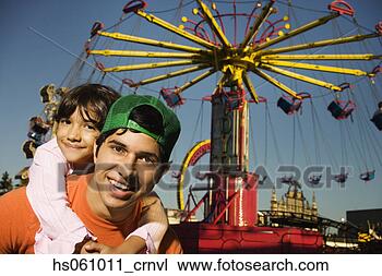 Stock Photo - father giving 
his daughter a 
piggy-back ride 
at a carnival. 
fotosearch - search 
stock photos, 
pictures, images, 
and photo clipart