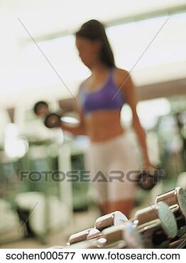 Picture - blurred image 
of a woman exercising 
with dumbbells. 
fotosearch - search 
stock photos, 
pictures, images, 
and photo clipart