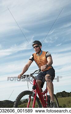 Stock Photograph - male cyclist riding 
under blue sky, 
california, united 
states. fotosearch 
- search stock 
photos, pictures, 
images, and photo 
clipart