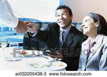 Stock Photo - businessman handing 
a credit card 
to a waiter. fotosearch 
- search stock 
photos, pictures, 
images, and photo 
clipart