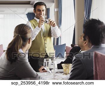 Stock Image - waiter taking 
a picture of businesspeople 
at a restaurant. 
fotosearch - search 
stock photos, 
pictures, images, 
and photo clipart