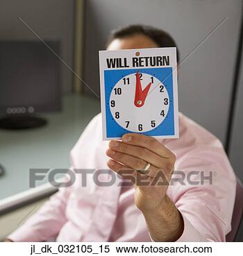 Stock Image - businessman holding 
a will return 
sign in front 
of his face. fotosearch 
- search stock 
photos, pictures, 
images, and photo 
clipart